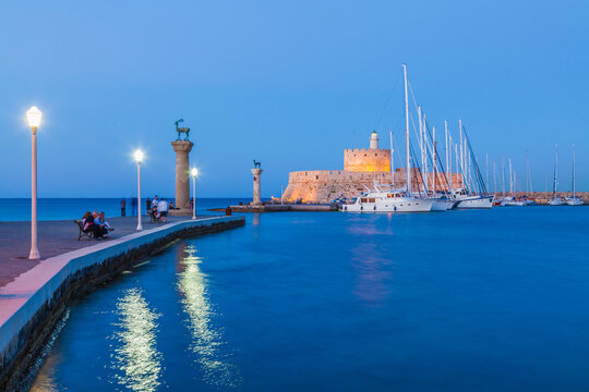 Greece, Rhodes, entrance to Mandraki harbour at blue hour