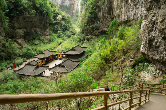 Ancient Chinese houses building surrounding  mountains and forest in the Three Natural Bridges in Wulong Karst National Geology Park (A UNESCO World Heritage Site in Chongqing China).