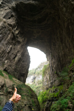 A huge cave hole in Wulong China look like thumb finger at  the Three Natural Bridges in Wulong Karst National Geology Park (A UNESCO World Heritage Site in Chongqing China).