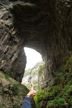 A huge cave hole in Wulong China look like thumb finger at  the Three Natural Bridges in Wulong Karst National Geology Park (A UNESCO World Heritage Site in Chongqing China).