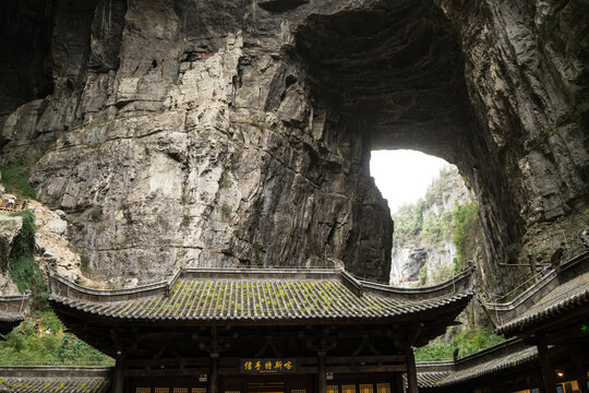 Chinese pavilionA with huge cave hole in Wulong China look like thumb finger at  the Three Natural Bridges in Wulong Karst National Geology Park (A UNESCO World Heritage Site in Chongqing China).