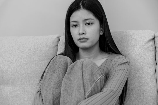 Monochrome picture, Depression and mental illness. Asian woman disappointed, sad after receiving bad news. Stressed girl confused with unhappy problems, cry and worry about unexpected pregnancy.