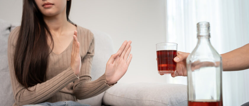woman refuses say no and avoid to drink an alcohol whiskey, stopping hand sign female, alcoholism treatment, alcohol addiction, quit booze, Stop Drinking Alcohol. Refuse Glass liquor, unhealthy