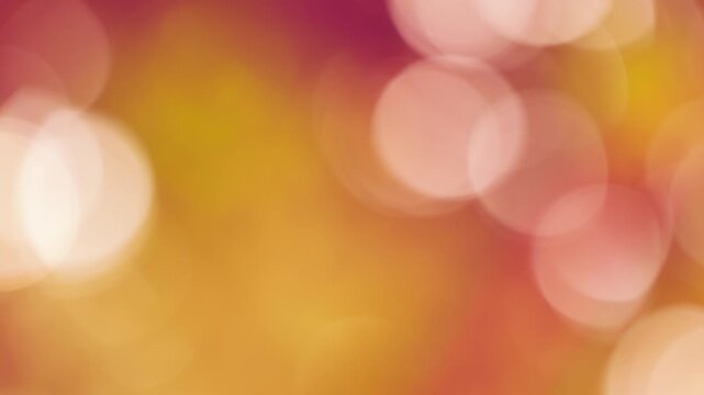 Dreamy pinkish-amber bokeh circles floating in warm dusk breeze, serene natural background