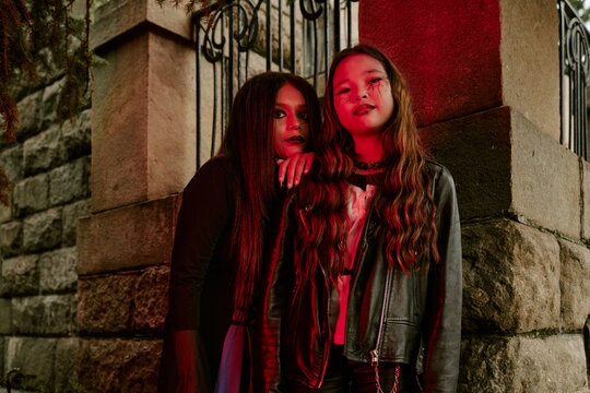 Portrait of diverse teenagers wearing spooky makeup and costumes for Halloween celebration outdoors. Image suitable for seasonal marketing campaigns and holiday event promotions