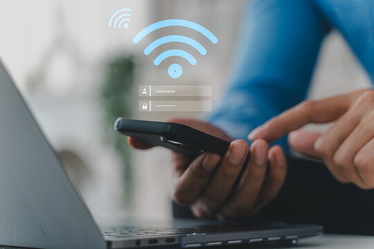 Person holding smartphone with glowing blue wifi icon on screen. Fast wireless internet connection, modern mobile network technology, digital communication and global smart device connectivity