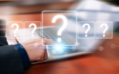 Obraz premium Business professional using a laptop with glowing question marks, representing uncertainty, research, decision making, problem solving, digital questions, information search, strategy, analysis.