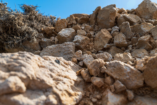 Pile of coastal boulders and rocks under a clear sky on Milos island