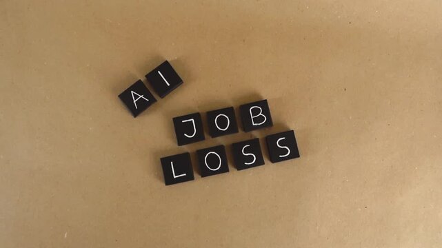 Black tiles spelling out the words AI Job Loss on a brown paper background, symbolizing the impact of artificial intelligence on employment, the workforce, and the future of labor