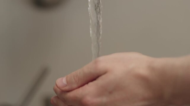 Slow motion man hand wash fresh ripe raspberries
