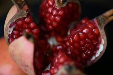Juicy Pomegranate Arils Revealed In Open Fruit Macro Close Up © Pixel Gravity Studio