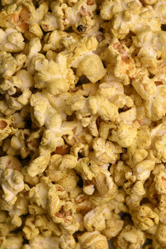 Extreme Macro Background Of Golden Seasoned Popcorn With Crispy Texture