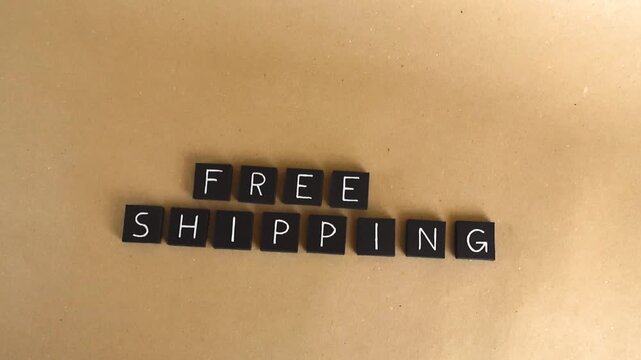 Black letter tiles spelling the words free shipping, arranged on a recycled brown kraft paper background, representing a popular e commerce and retail customer incentive