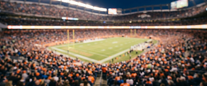 Fully blurred professional football stadium packed with spectators, soft floodlights and a distant green field creating an energetic sports atmosphere for advertising, tournaments and marketing.