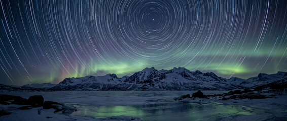 Long Exposure Star Trails with Green Aurora Borealis Over Arctic Lake, Northern Lights Night Landscape © Olha
