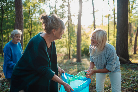 Senior women volunteering for nature protection and litter collection.