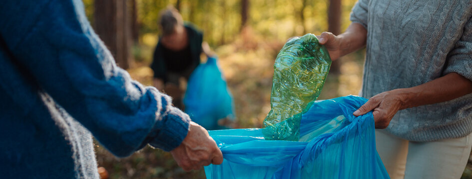 Senior women volunteering for nature protection and litter collection.