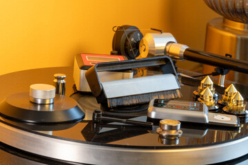 Record turntable vinyl player accessories showing a collection of brushes, scales, level, record clamp and spike feet. © alexander
