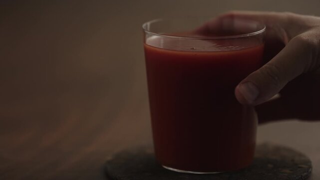 Slow motion man hand take tomato juice in a glass