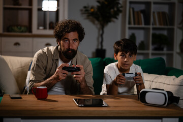 Father and son enjoying video game together at home © Zoran Jesic