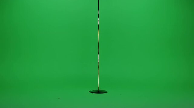 Green screen studio with falling microphone during a dramatic lighting setup