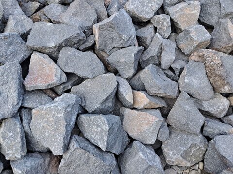 Crushed stone rocks texture background, coarse gravel aggregate and crushed basalt for road construction and civil engineering.