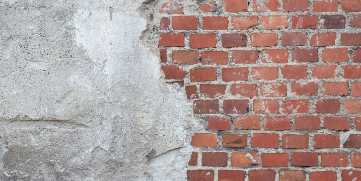 Old red brick wall with cracked concrete plaster overlay background texture