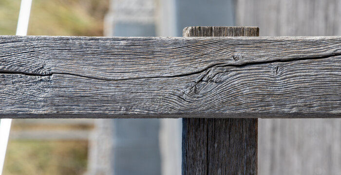 Old weathered wooden fence rail texture with natural grain and cracks