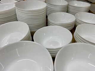 Stack of clean white ceramic bowls in a close-up view, minimalist kitchenware and tableware...