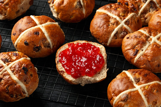 Traditional Hot Cross Buns, Easter Sweet Spiced Rolls with Dried Fruit, Strawberry Jam and Butter