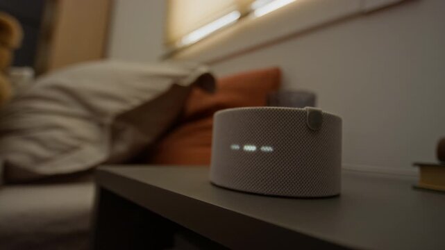 Smart speaker on bedside table displaying digital clock time and transitioning to voice assistant animation. Ideal for smart home technology promos and consumer IoT device marketing videos