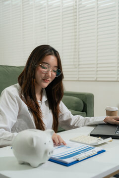 woman sitting at desk managing expenses, calculating expenses, paying bills using laptop online, making household financial analysis, Save money to future It is the concept of provident fund.