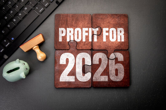 PROFIT FOR 2026 Puzzle Signals Business Growth Beside Piggy Bank and Keyboard