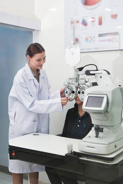 Female patient eye exam with refractometer device, vision and eyesight improvement by expert optometrist woman, diagnostic for eyeglasses lens, professional technology services in optical clinic.