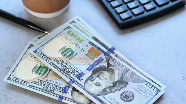 Person counting money 100 US dollars in the office, video 4k resolution
