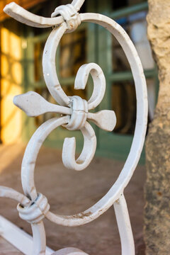Wrought Iron Decorative Railing Detail Closeup With White Vintage Scrollwork and Architectural Ornament