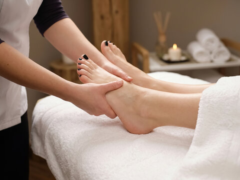 Spa Therapist Giving Relaxing Foot Massage to Woman