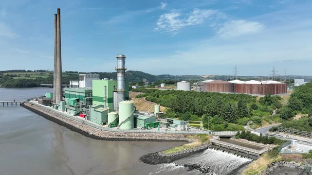Drone footage of a thermal power plant on the banks of the River Suir in County Wexford, featuring energy production and waterfront scenery.
