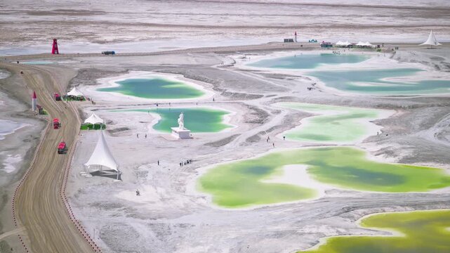 Aerial View of Salt Bridge Causeway in Dachaidan Emerald Lake Core Zone: Green and Blue Mineral Ponds, White Salt Crust in Qinghai
