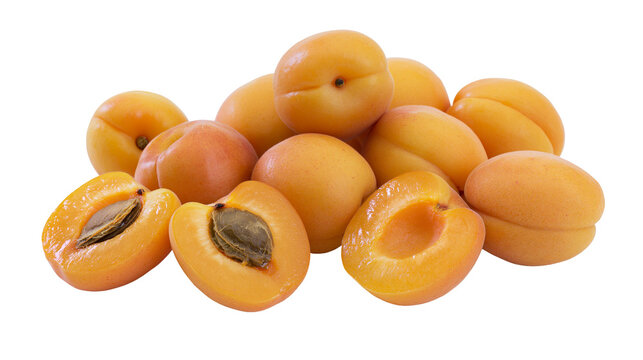 Heap of fresh ripe apricots, whole and halved with pits