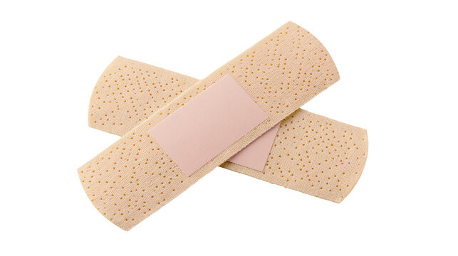 Two beige adhesive bandages crossed over each other