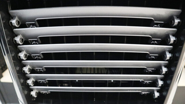 Close-up front view of an air cooler louver vent with horizontal adjustable slats and mechanical joints