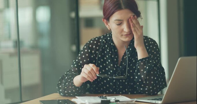 Businesswoman with eye pain at the office