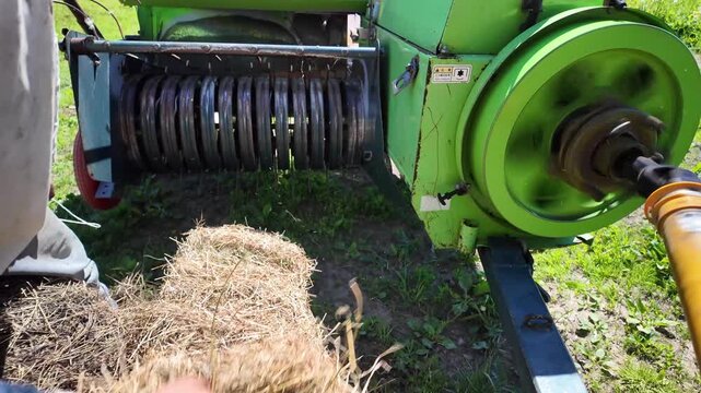Hay Baler Feeding Loose Hay Into Compression Chamber