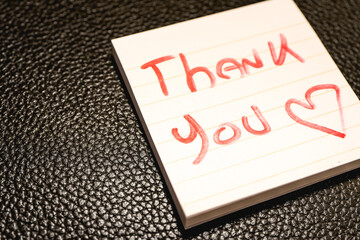 A handwritten note with the text Thank You  on it. © Sonny
