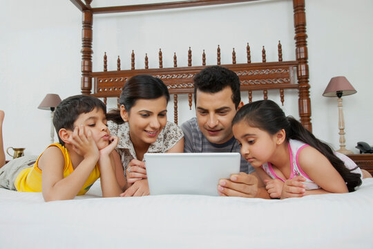 Family looking at a digital tablet