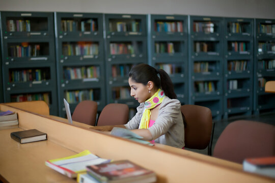 College student with laptop in library