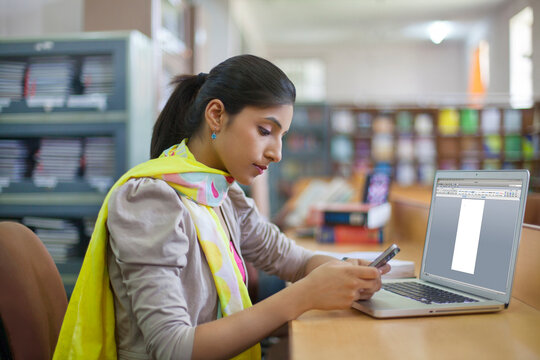 College student looking at sms on mobile phone