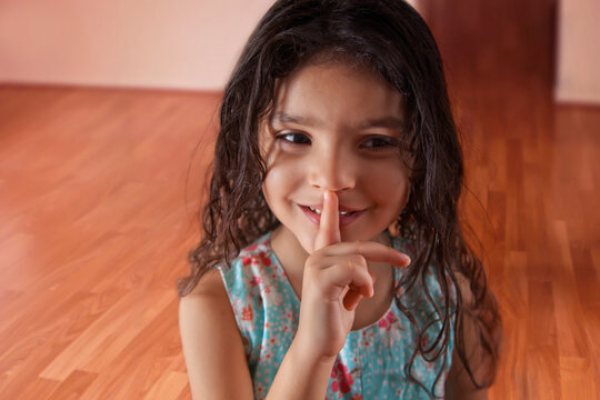 Little girl with finger on lips