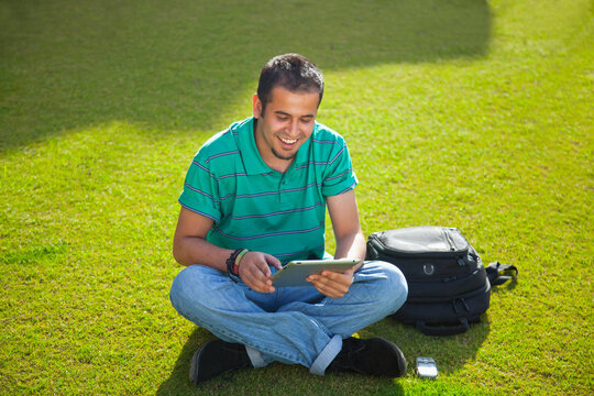 Teenager with digital tablet smiling